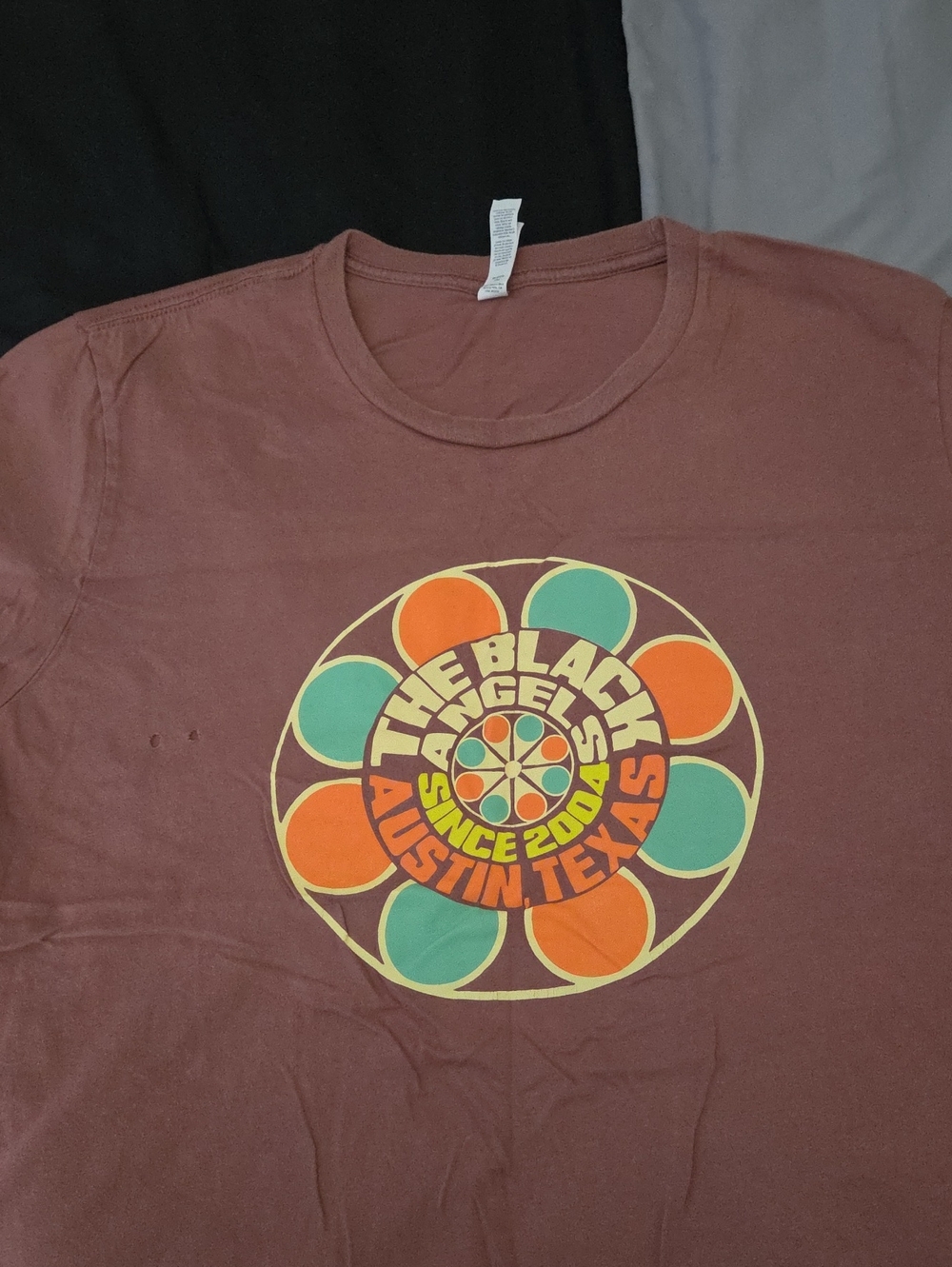 Black Angels. Graphic Tee with Orange and Teal Accents